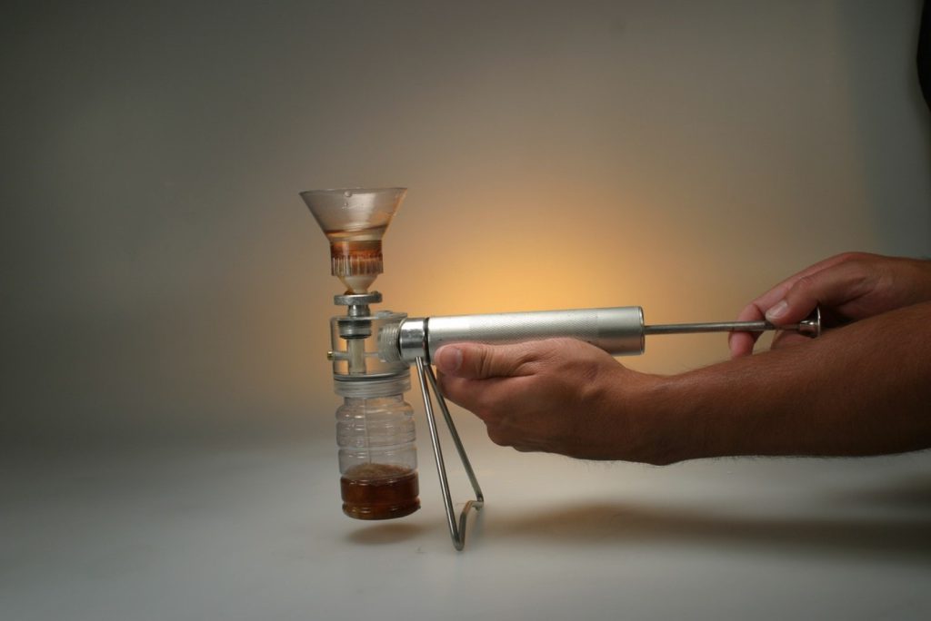 A example of a patch test kit in use with the oil being pushed through a membrane with a manual pump