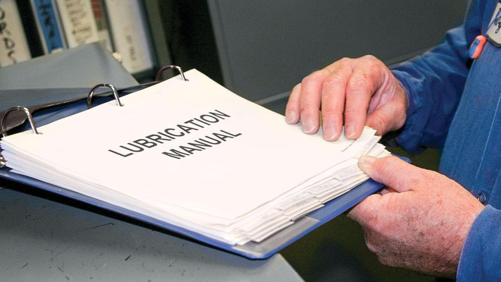A lubrication manual of procedures in a three-ring binder kept at a plant.